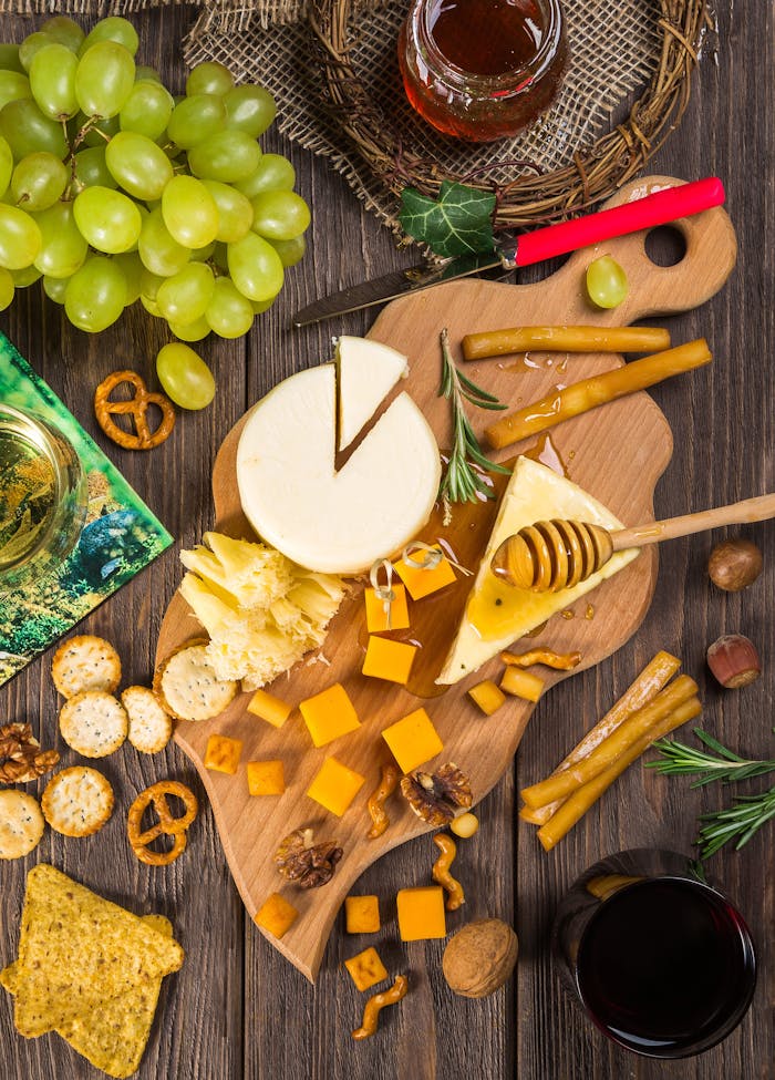 The Art of Drawing Readers In: Your attractive post title goes here A delicious assortment of cheeses, crackers, and grapes on a wooden board for a gourmet appetizer.
